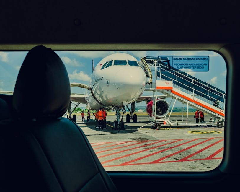 Traveler with luggage standing in airport departure terminal